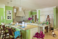 Traditional  style goes bold in the kitchen where white crown and box moldings are offset by lively leaf-green walls.