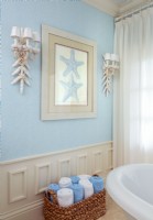 A starfish print and shell-studded wall sconces woes the near-by beachside location.