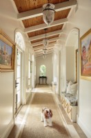 Dutchy, the family Cavalier King Charles spaniel, greets guests at the front of gallery that wraps around the house.