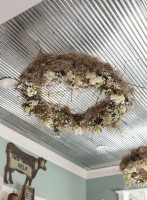 Rather than hung on a wall, wreathes are suspended from the ceiling.