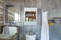 Metal accessories are used for continuity in the bathroom