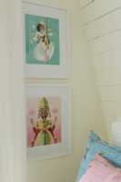  A pair of framed Indian prints echoes the colors of the bed pillows.