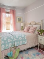 A vintage bedspread won an iron bed .