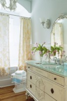 A country French antique dresser is retrofitted as a vanity.