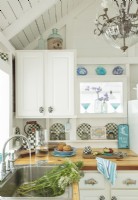 Aqua- blue accents and black and white accents po pop against white woodwork.