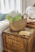 An antique tobacco chest serves as a side table and adds a rustic accent to the eclectic furnishings. 
