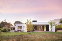 Modern house with open metal screens in countryside setting