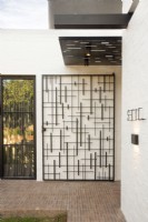 Metal gate at entrance to modern home