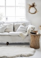 White country living room with rustic wreath on wall