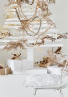 White wooden Christmas tree decorated with natural materials