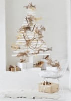 Modern wooden white Christmas tree decorated with natural materials 