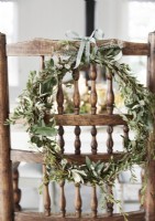 Detail of natural wreath on rustic wooden chair