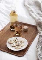 Detail of tray with cookies and tea on bed