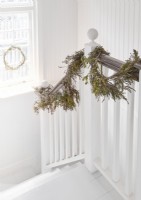 White painted country staircase with rustic garlands and wreath