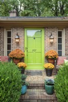 A lime-green door and colorful pots of flowers announce Debbie's love of cheerful hues.