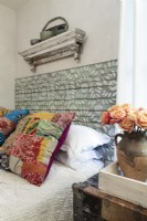 Stenciled salvage planks are fashioned into an exotic headboard.