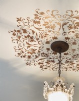 Stenciled work highlights  vintage chandelier.