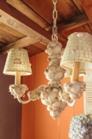 A shell covered chandelier pays tribute to the coastal location.