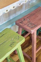 Rw wood stools sport a variety of colors and carved the the children initials.
