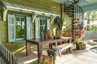 A  wood awning and decorative shutters give the pool deck a Caribbean flavor.