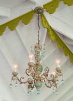 An irons and porcelain chandelier crowns the master bedroom.