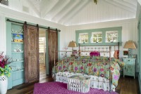 The master bedroom features vintage shutters converted into a sliding door using classic barn hardware.