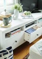 Drawers and cubbies keep linens, board games and books organized and easy to grab.