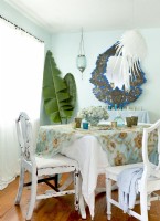 The weathered dining room table is given a face-lift with an embroidered sari laid atop a white cotton sheet. 