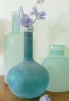 Frosted glass in oceanic colors evoke the coastal setting.