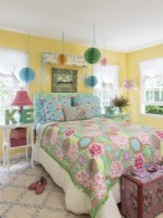  Playful accents join fabrics in pumped up pastels. Sunny yellow walls wrap it all up.