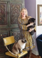 Kitties, Hershey, a Ragdoll, and Minky, a Persian, appreciate Bridget's fondness for comfy chairs and balls f yarn