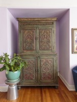 An armoire carved and pained in India provides a much-needed closet In Bridget's 800-square-foot home.