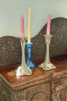 Silver and turquoise candlesticks perch on a carved sideboard Bridget brought back from a trip to Goa in western India.