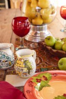 Handcrafted Italian pitchers and plates share the limelight with ruby red glasses.  