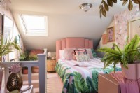 Pale pink attic art deco style bedroom with skylight window