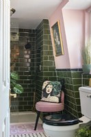 Green tiled and pink painted bathroom and shower cubicle