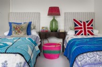 Colourfully dressed twin beds