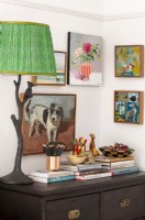 Corner with lamp, art, ornaments and books