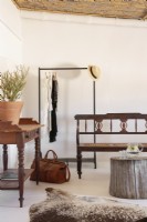 Clothes rack, tree stump and antique furniture