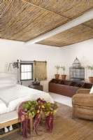 Bedroom in converted stable with reed ceiling