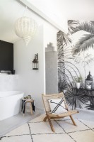Modern bathroom with chair and grey and white feature wall
