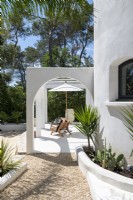 Built-in pergola on white terrace of country house in summer