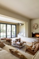 Lit modern fireplace in neutrally decorated living room 