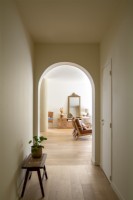 View through archway in corridor into living room