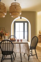 Vintage style dining room with sunlight pouring through glass door