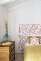 Vintage style bedroom with floral wallpapered bed head