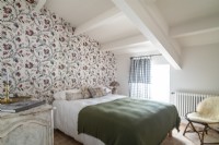 Floral wallpaper feature wall in country bedroom