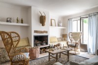 Wicker armchairs in neutrally decorated country living room