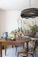 Floral vintage chairs and colourful ceramic collection in dining room