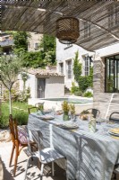 Shaded outdoor dining area on terrace of rustic country house